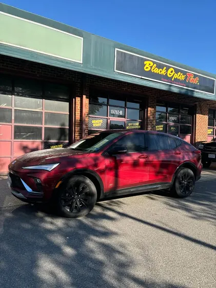 Red Toyota crossover outside the shop